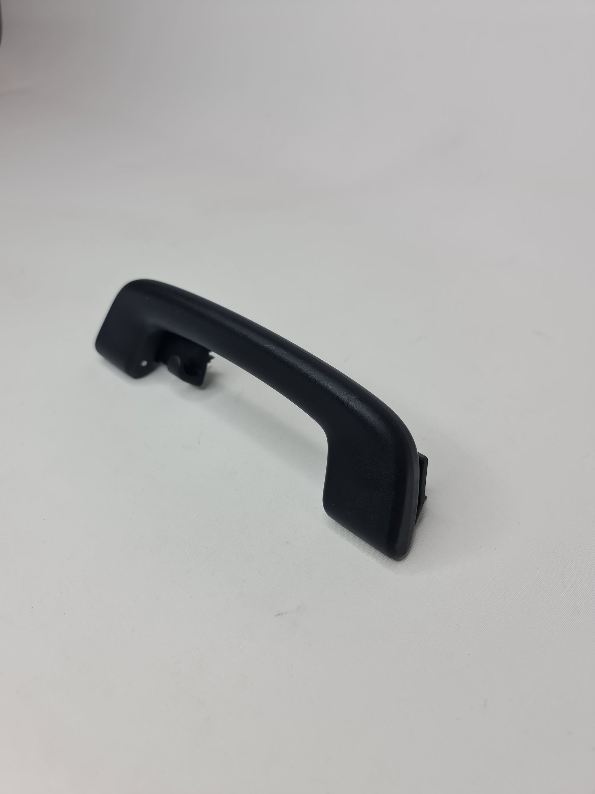 Black F80 roof grab handle arm holder from MPerformance.parts, mounted inside a vehicle for secure support.