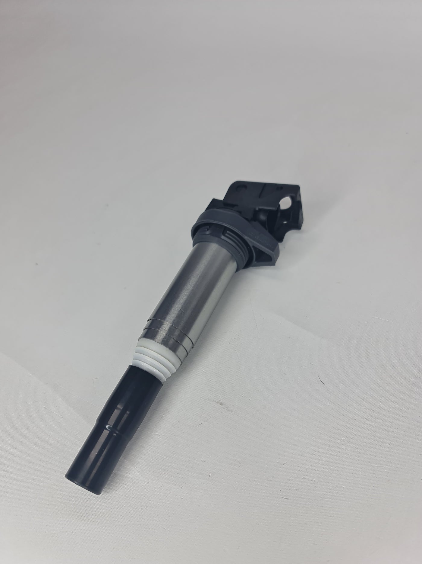 BMW ignition coil for models 2001-2020, part 12-13-8-616-153, showing the black coil with electrical connectors.