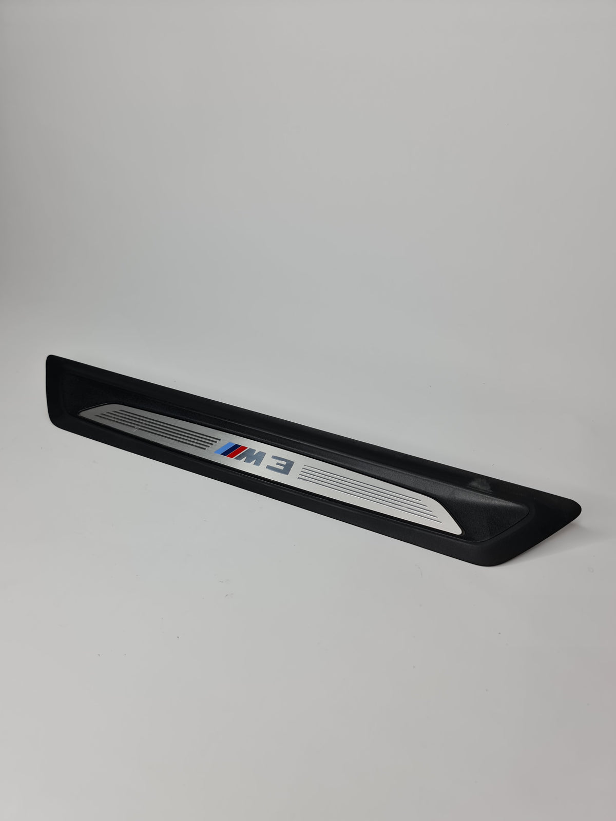 BMW 2015-2018 M3 front entrance cover, part number 51478055779, showing close-up of the black plastic exterior component