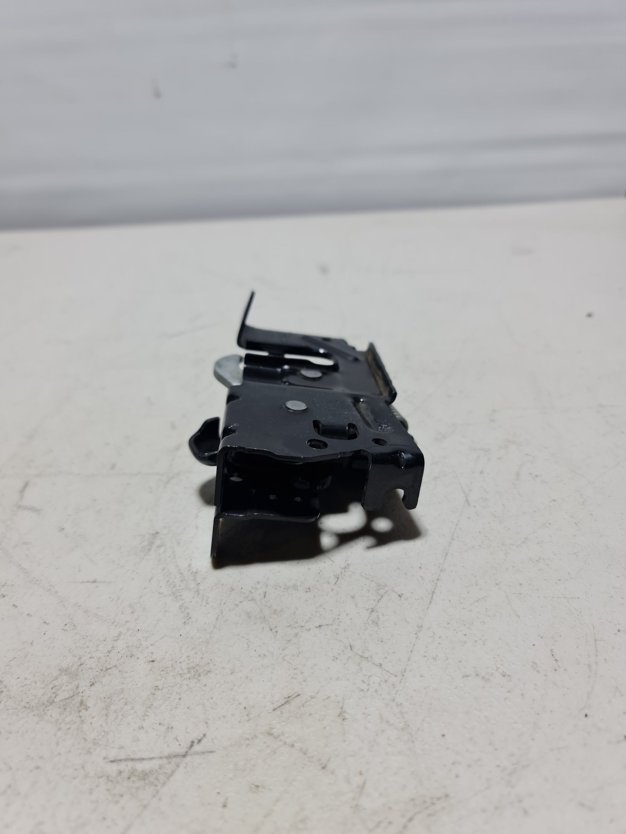 BMW 2012-2020 left hood lock actuator latch assembly, part 51-23-7-242-548, showing the metal latch mechanism.