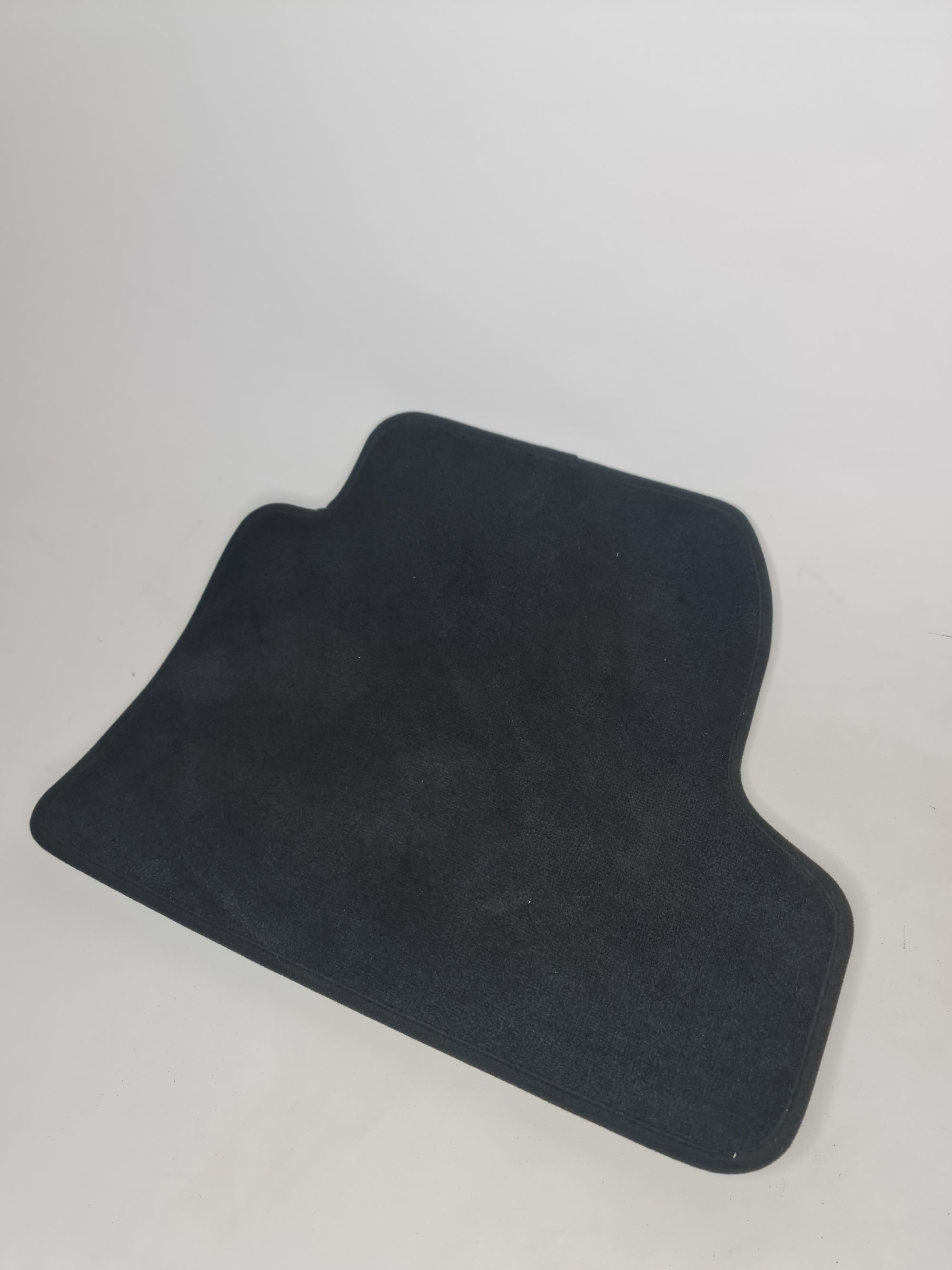 F82 M4 rear right floor mat from MPerformance.parts, black rubber with textured surface for vehicle interior protection.