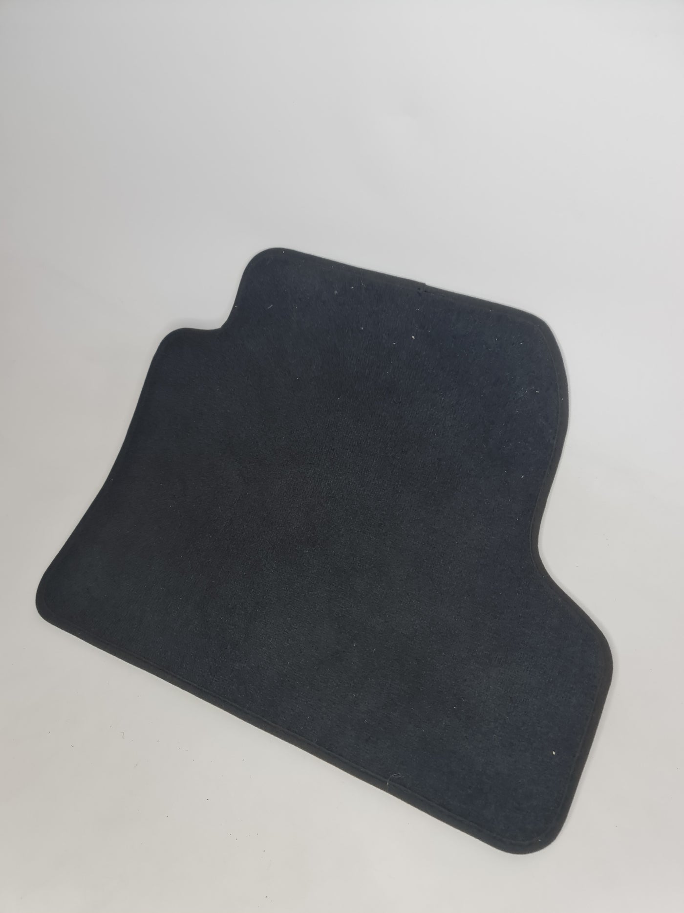 Black rear left floor mat for BMW F82 M4 by MPerformance.parts, showing textured rubber surface and tailored fit.