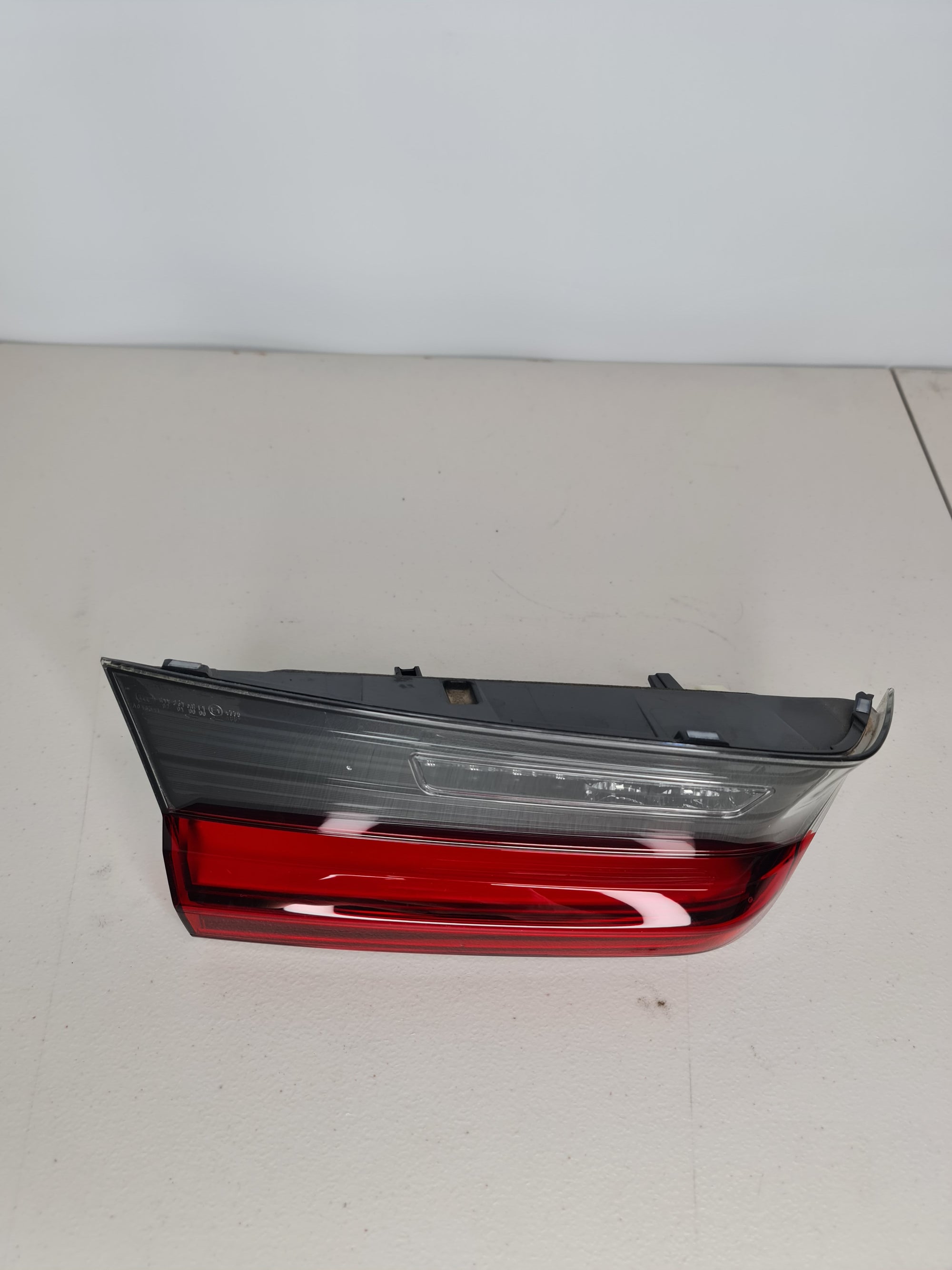 BMW M3 G80 left LED inner trunk lid taillight OEM, showing the sleek design and LED lighting elements on the tail light assembly.