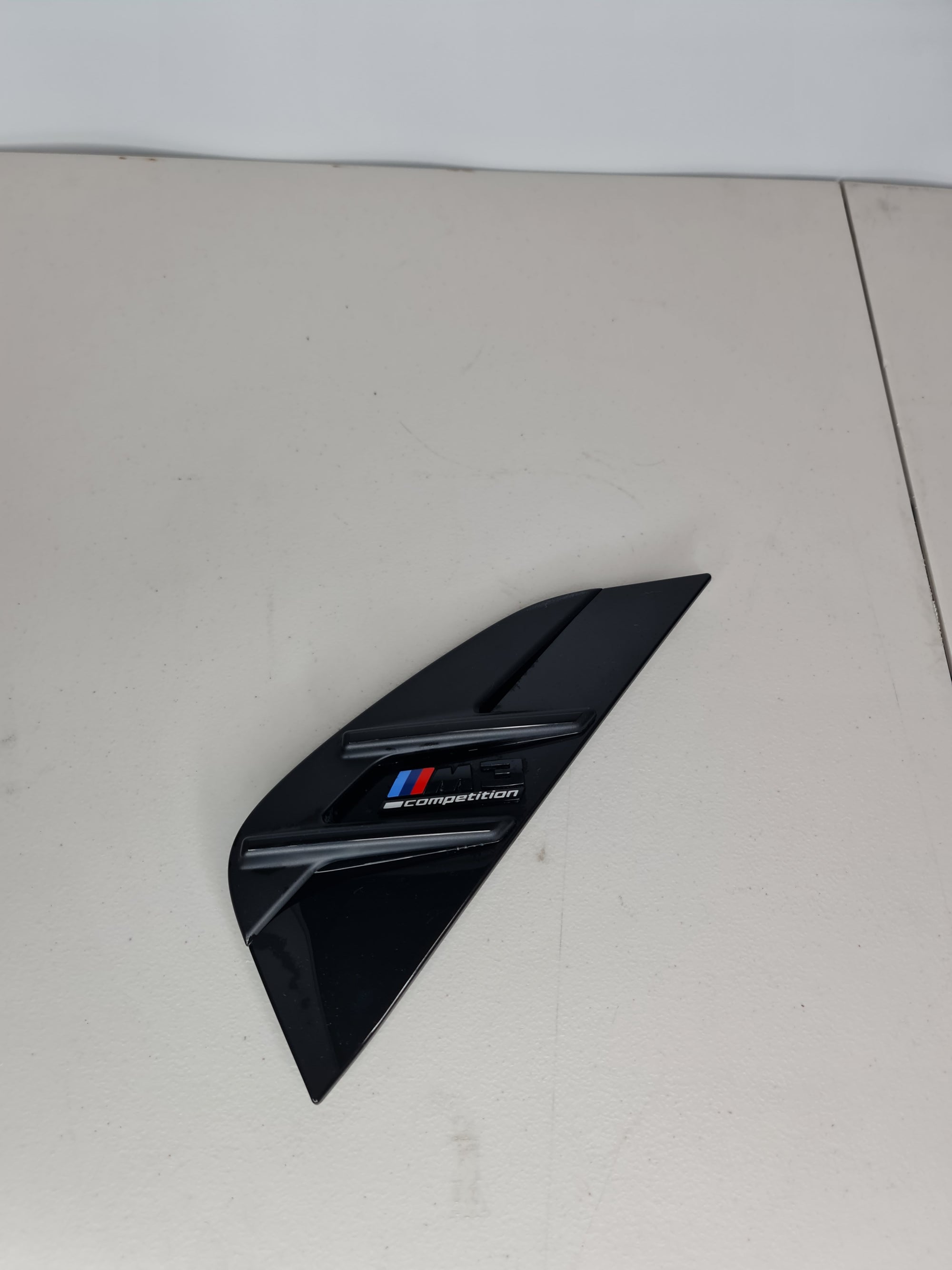 BMW 3 Series G80 M3 Competition passenger side left wing trim, black plastic, fits vehicle with MPerformance.parts branding.