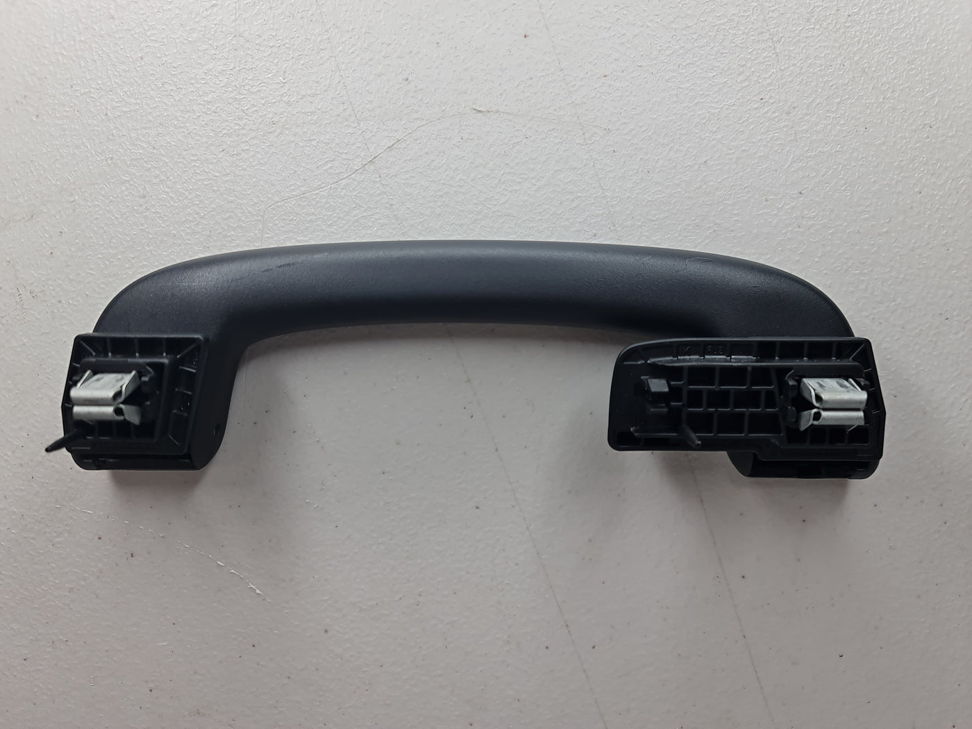 Black F80 Roof Grab Handle Arm Holder by MPerformance.parts, showing the sturdy, sleek design for vehicle roof support.