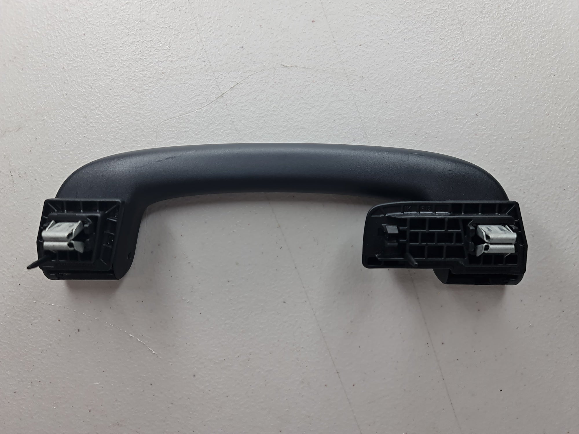 Black F80 Roof Grab Handle Arm Holder by MPerformance.parts, showing the sturdy, sleek design for vehicle roof support.
