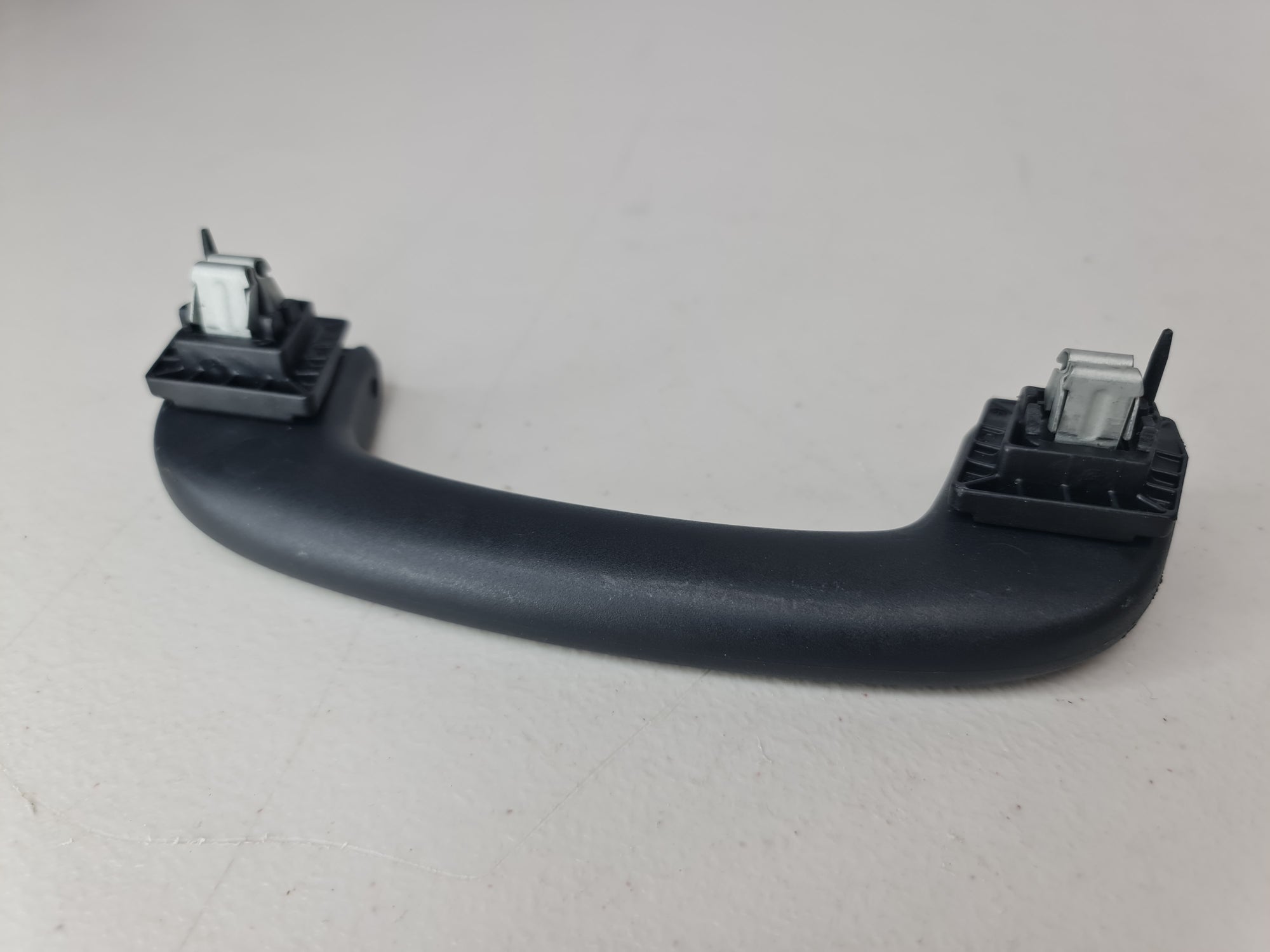 Black G80 roof grab handle arm holder by MPerformance.parts, featuring a sturdy design for vehicle interior support.