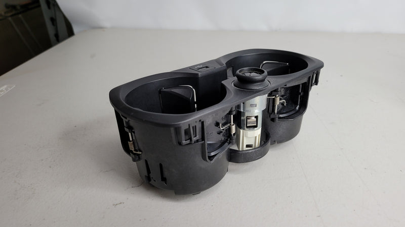 BMW M3 G80/81/82/83 MPerformance.parts center console cup holder with 12V charger and USB plug, mounted in the vehicle interior.