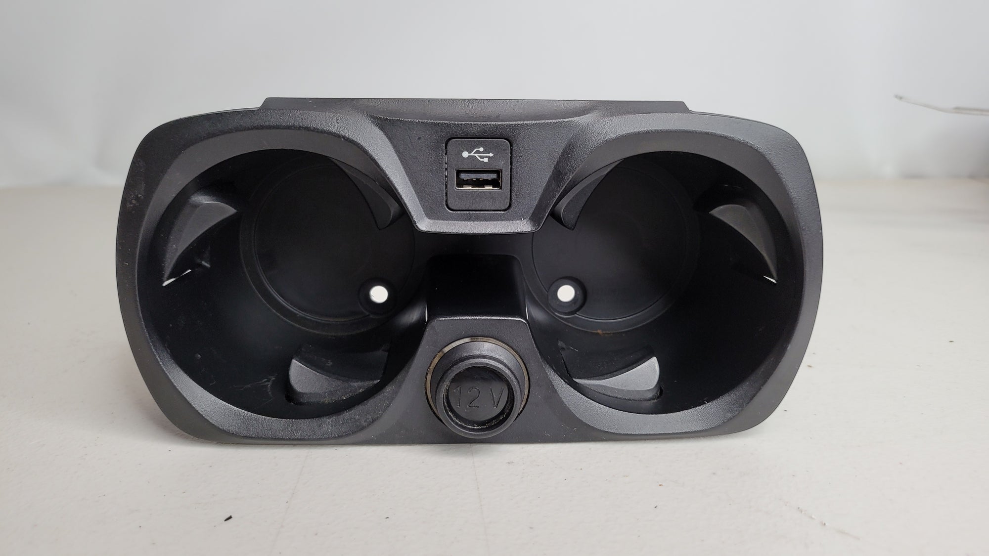 BMW M3 G80/81/82/83 Competition OEM cup holder assembly with 12V charger and USB plug, featuring sleek interior design.