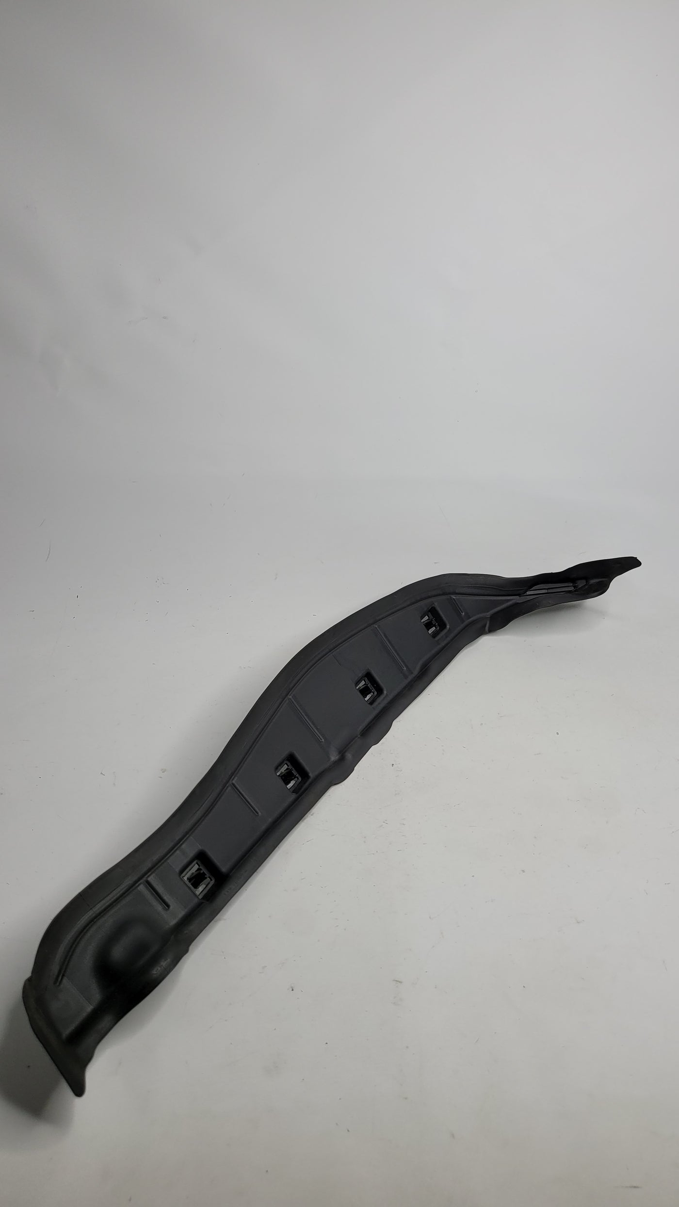 BMW M3 G80 front left inner fender door seal trim cover, part 7433819, shown on the vehicle's wheel well area.
