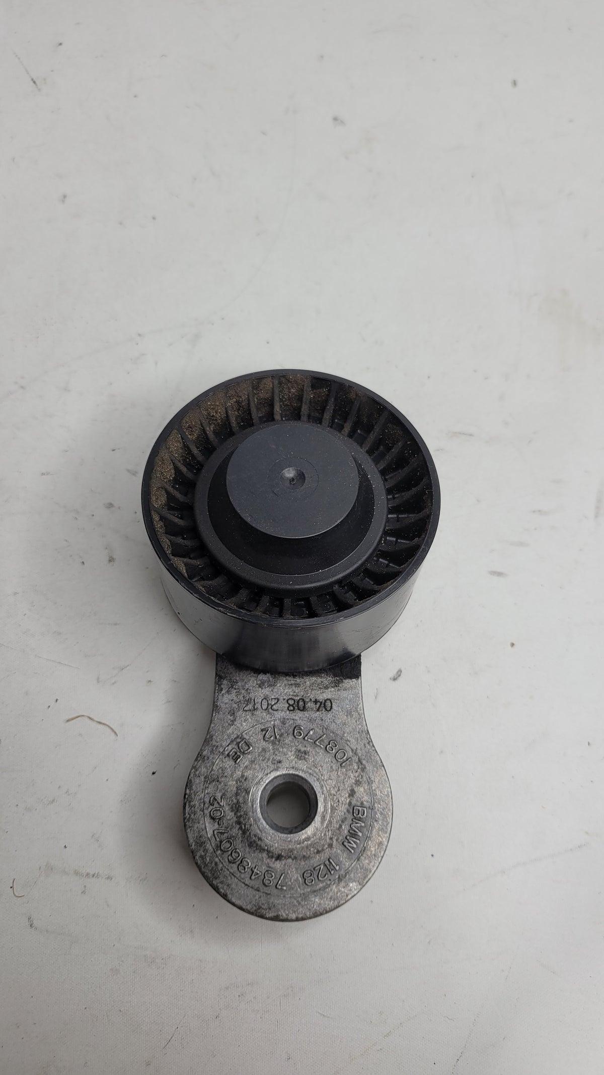 BMW MPerformance.parts 05175-M part, close-up of metallic component with branding, showing detailed surface and finish.