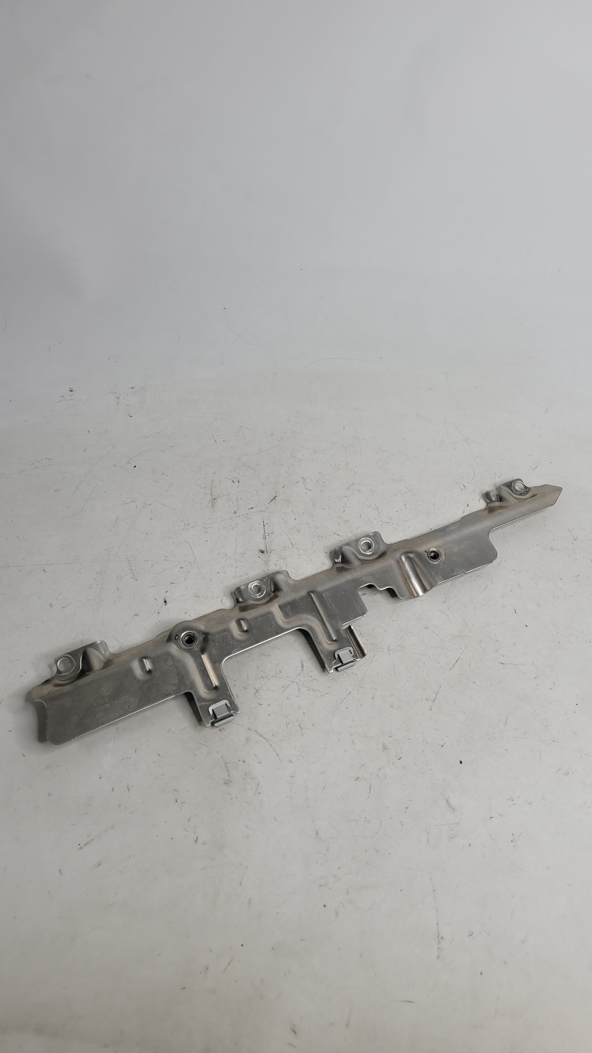 BMW M3 M4 G80 G82 G83 upper heat shield panel cover by MPerformance.parts, showing the black metal component with mounting points.