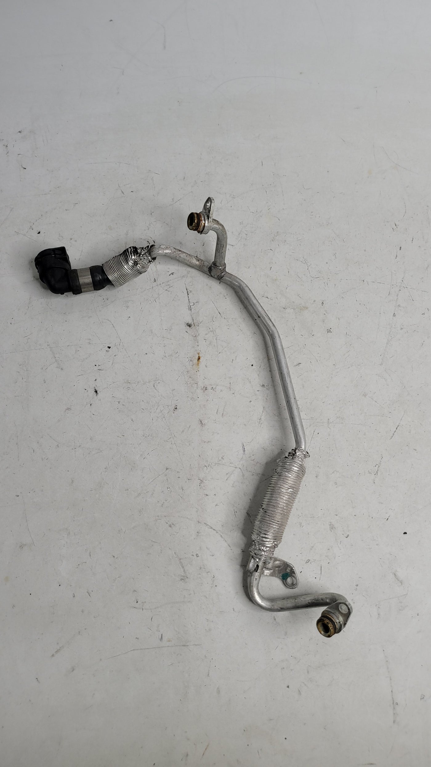 BMW F82 M4 turbocharger coolant pipe by MPerformance.parts, showcasing the aluminum pipe with mounting brackets and connections.