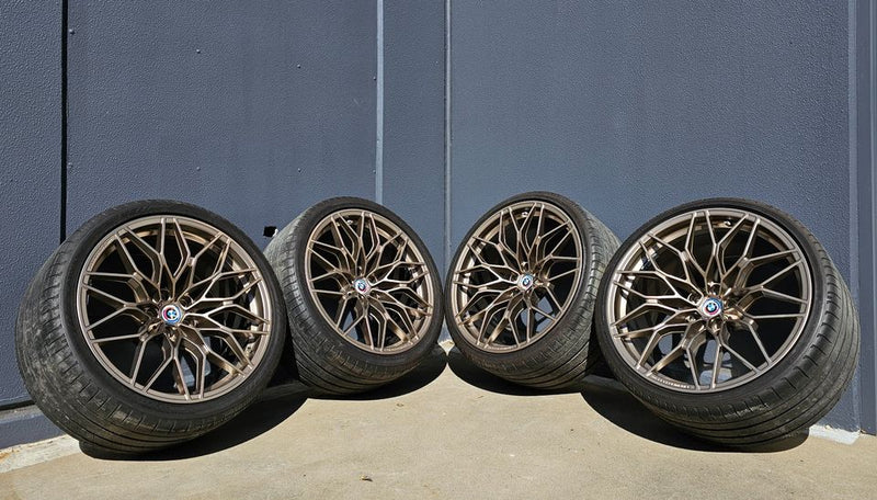 BMW 1000M forged lightweight wheels with tires and TPMS for G80 G81 G82 G87 M2 M3 M4 series, displayed on a vehicle.