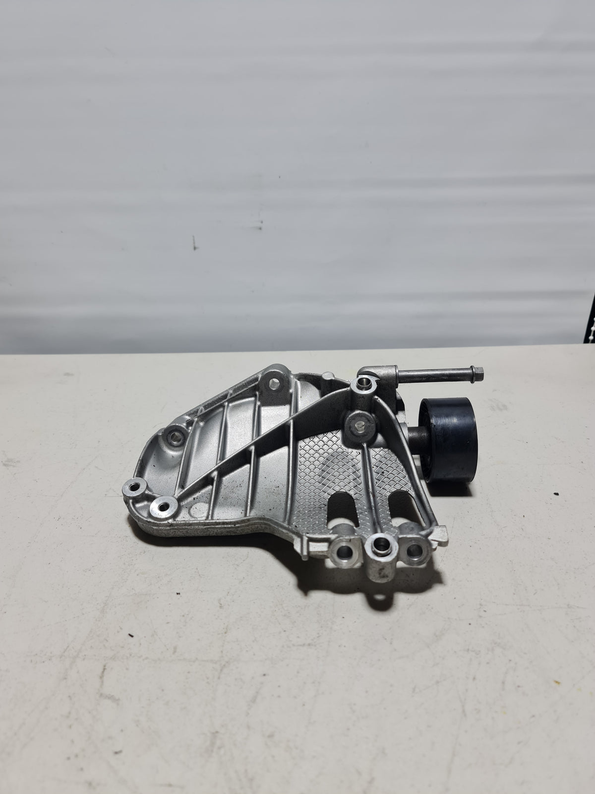 BMW A/C compressor bracket mount pulley for 2008-2020 models, part number 64-55-7-585-167, shown in the image.