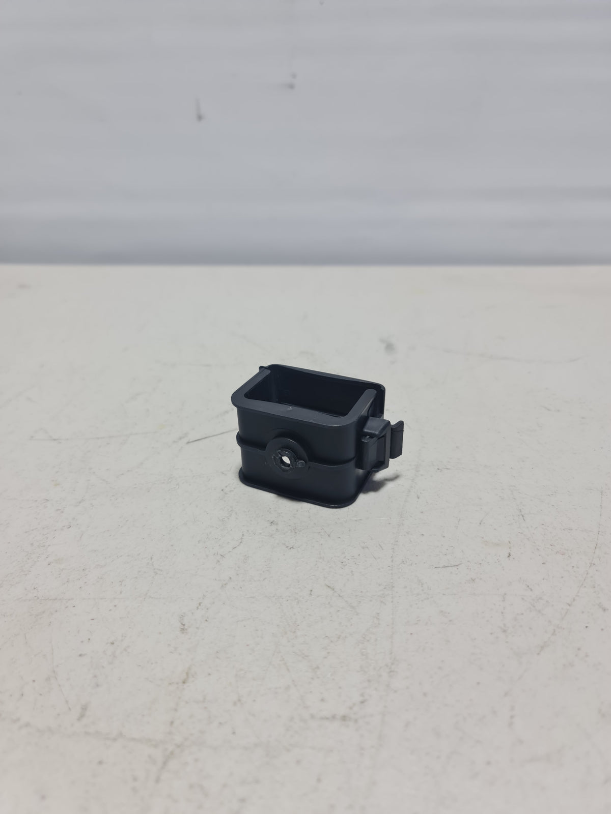 BMW hazard warning triangle bracket for 2007-2020 models, black mounting bracket with secure clip attachment.