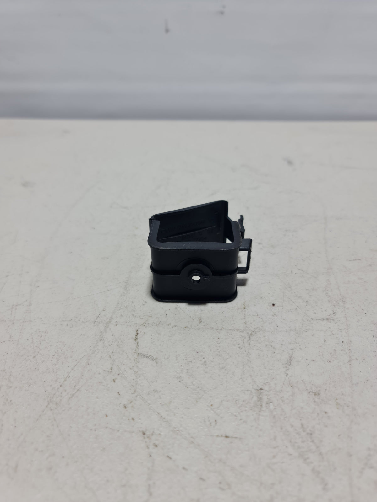 BMW hazard warning triangle bracket for 2007-2020 models, black plastic mounting bracket for hazard warning light assembly.