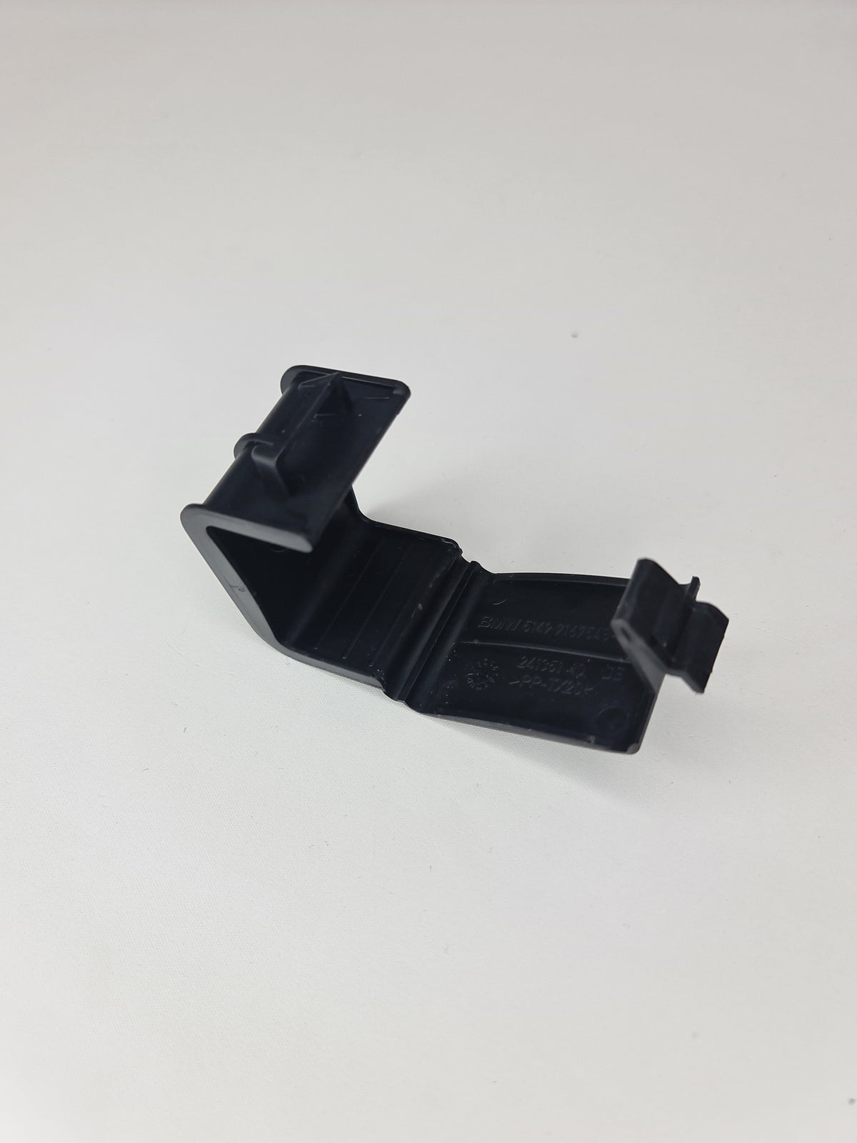 BMW hazard warning triangle bracket for 2007-2020 models, black plastic mounting bracket with metal clip attachment.