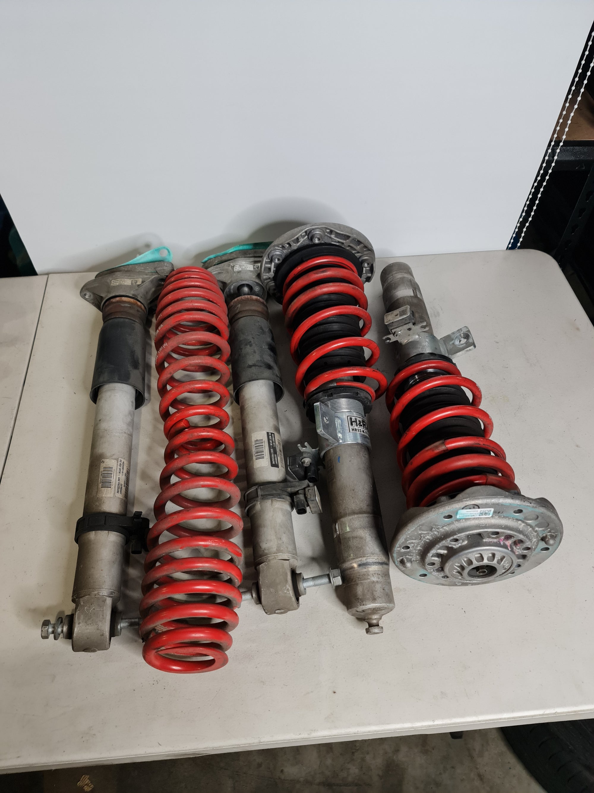 BMW M2 M3 M4 F80 F82 F87 H&R Springs installed on factory EDC height-adjustable struts in a clean engine bay.