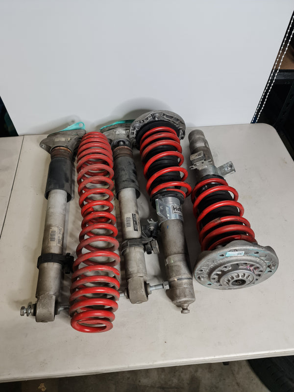 BMW M2 M3 M4 F80 F82 F87 H&R Springs installed on factory EDC height-adjustable struts in a clean engine bay.