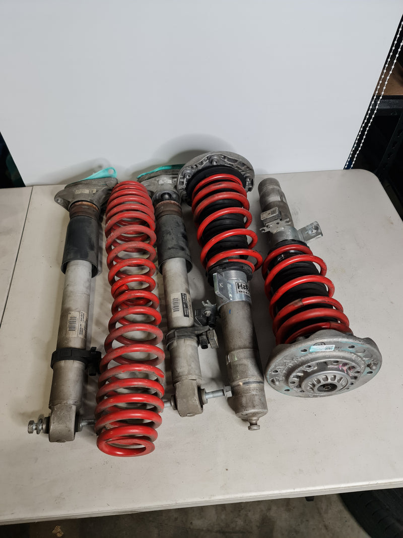 BMW M2 M3 M4 F80 F82 F87 H&R Springs installed on factory EDC height-adjustable struts in a clean engine bay.