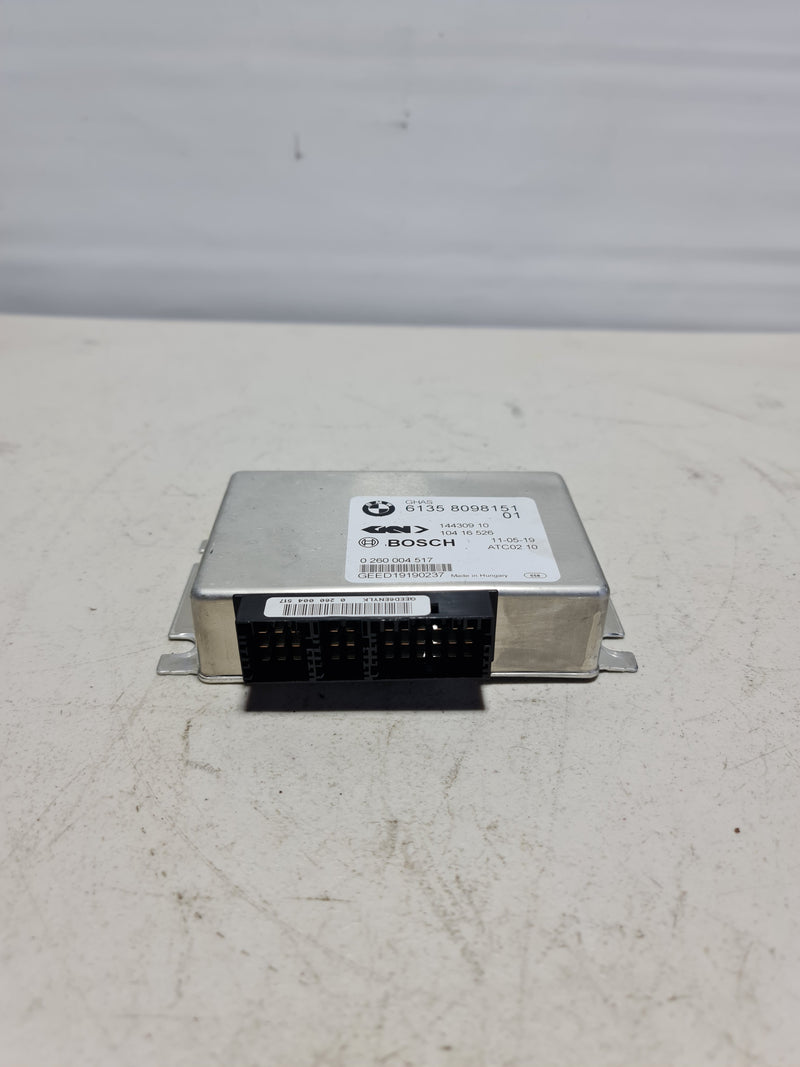 BMW control unit for regulated differential lock, part number 012-2020, with black rectangular module and connection ports.