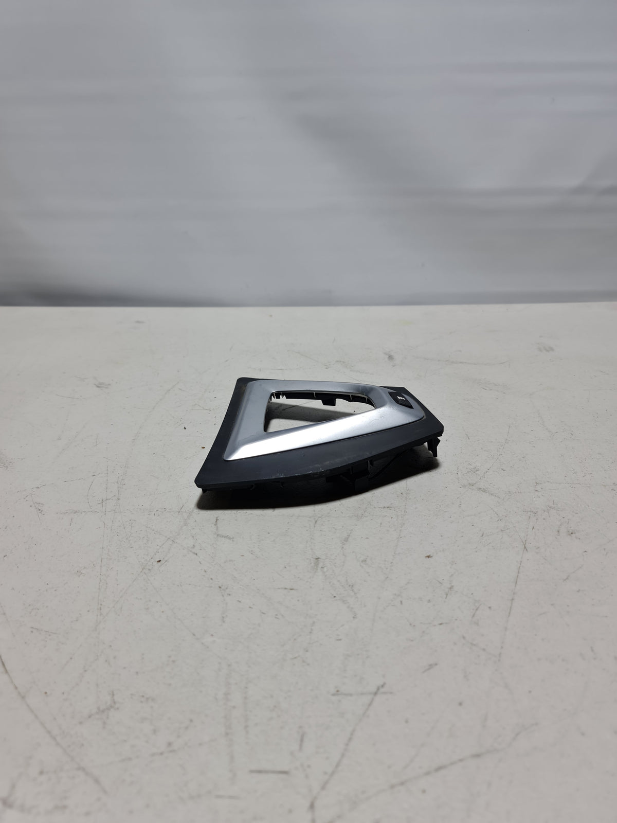 Original BMW gear selector switch cover 51168091220, a replacement part for the gear selector switch in BMW vehicles.