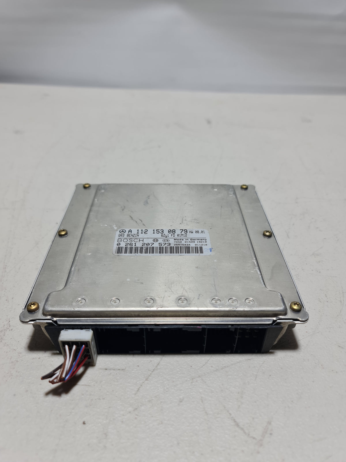 BMW ECU ECM engine control module unit OEM 0261207573, close-up of the black automotive ECU component with connectors.