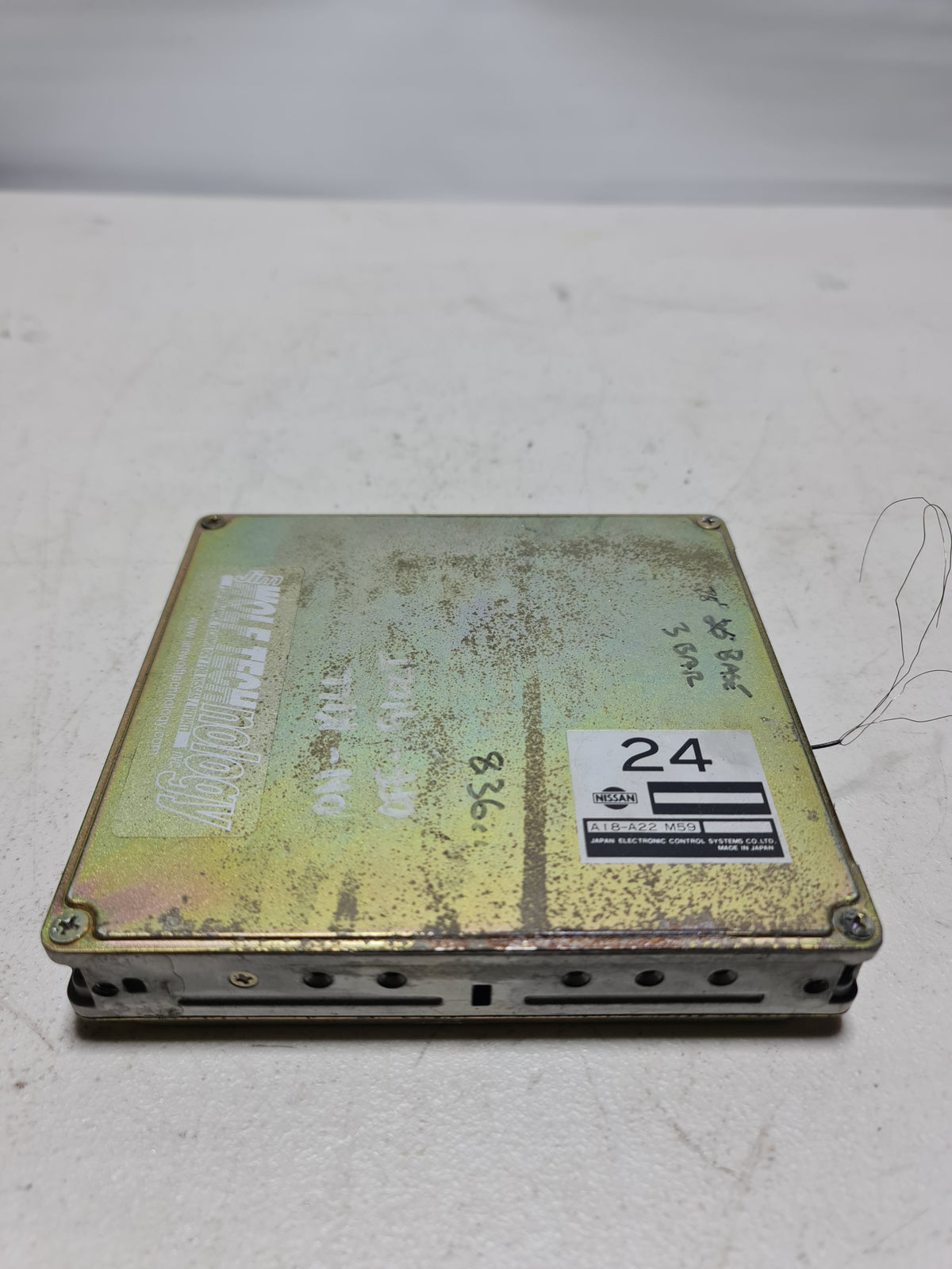 BMW 1990 non-turbo M/T ECU engine control module A18-A22 M59, close-up of the electronic control unit for vehicle engine management.