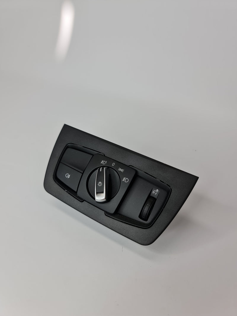BMW M3 F80 headlight switch control unit with labeled buttons and connection ports, designed for vehicle lighting control.
