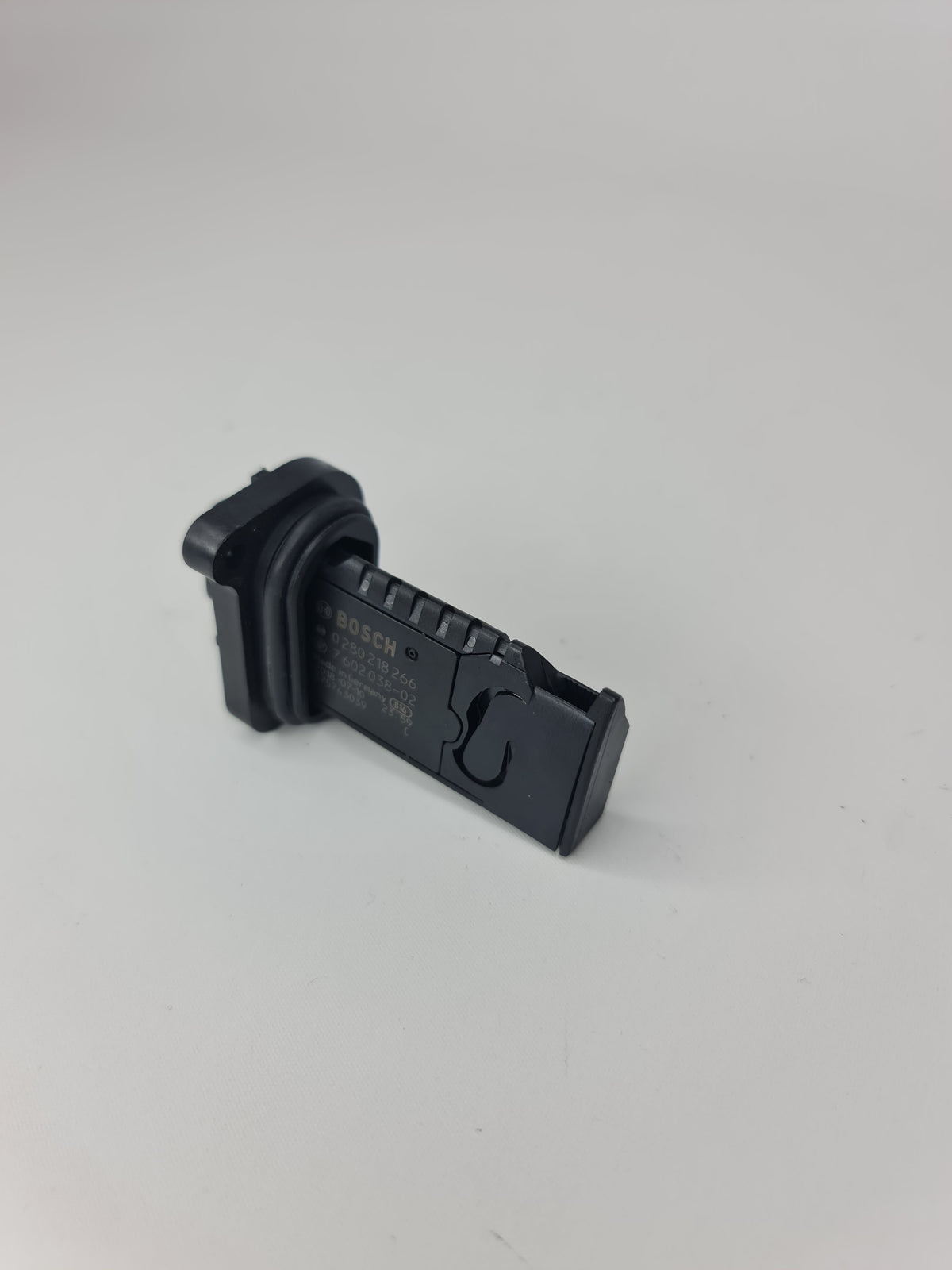 BMW 13-62-7-602-038 hot-film air mass meter for 2012-2020 models, close-up of the mass air flow sensor.