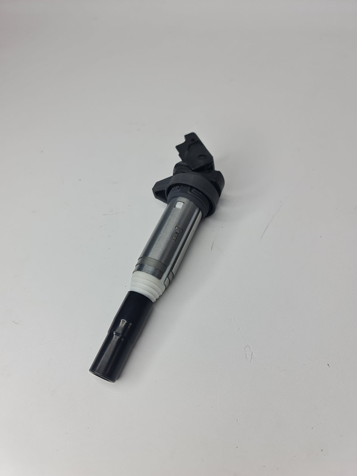 BMW ignition coil for 2001-2020 models, part number 12-13-8-616-153, showing the coil's cylindrical shape and electrical connections.