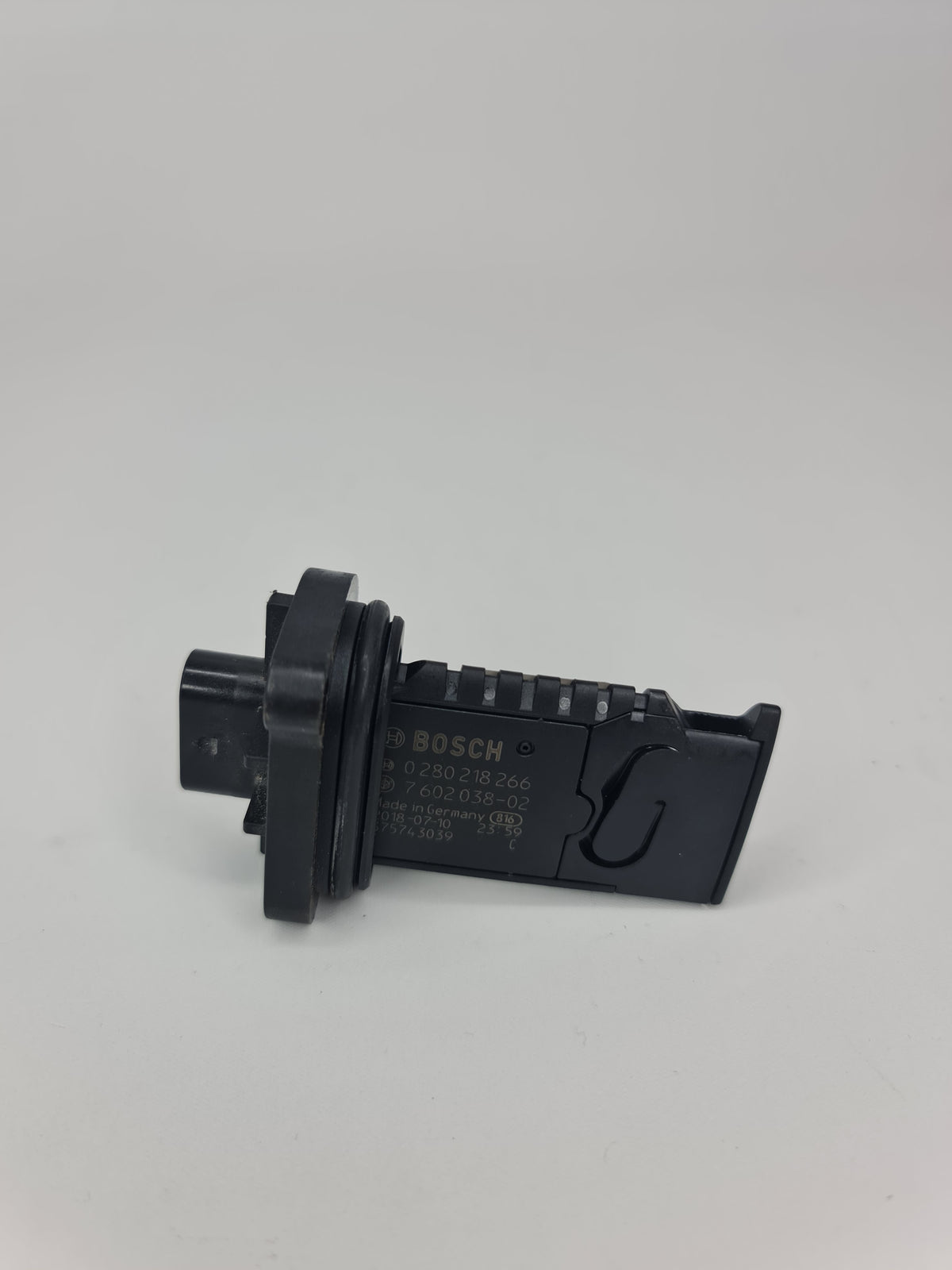 BMW ignition coil 2001-2020 model, with black plastic casing and electrical connectors, designed for engine ignition system.
