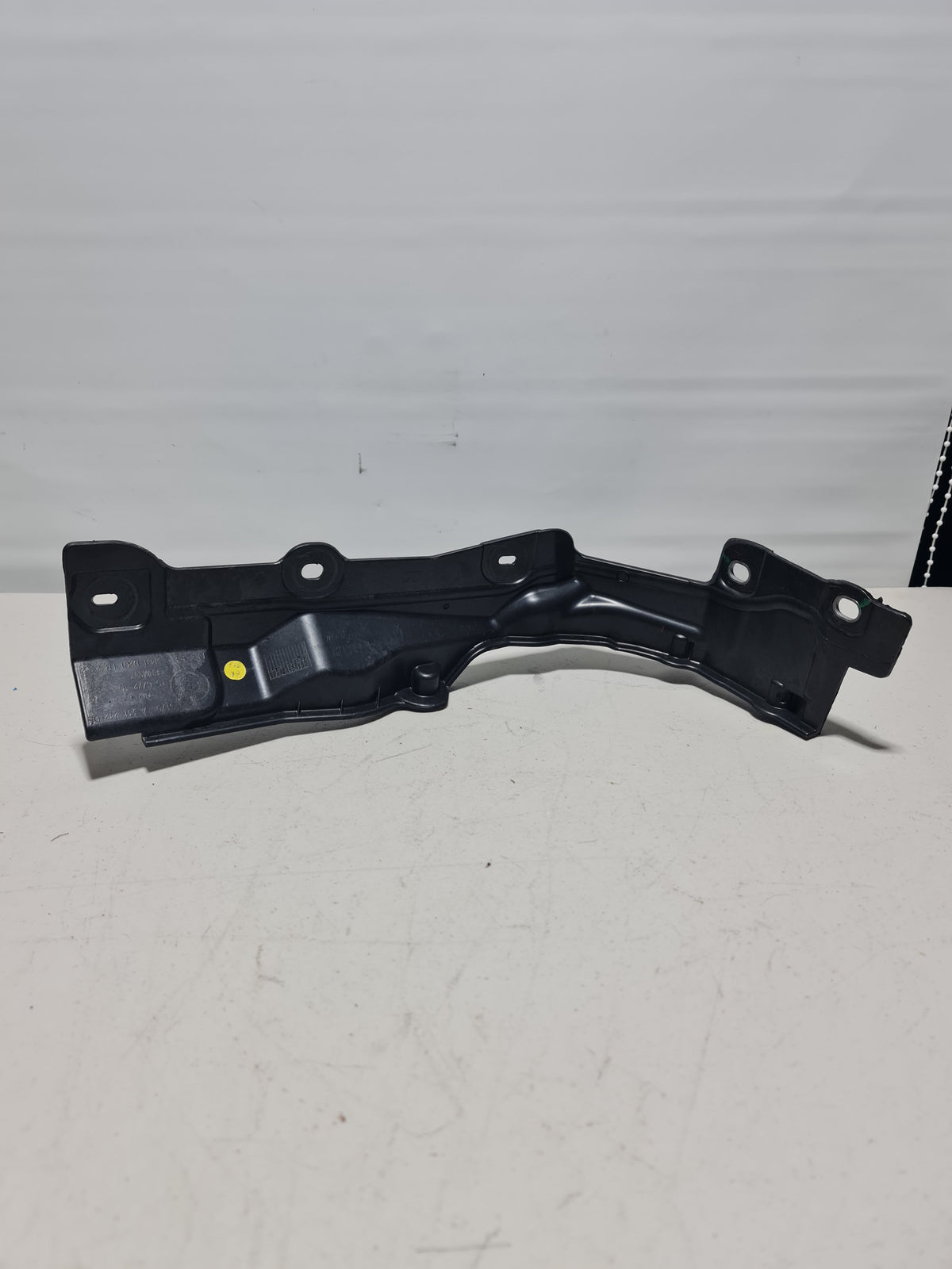 BMW 2012-2020 lower right partition wall for equipment area, part number 51-75-7-331-242, in black plastic with mounting features.
