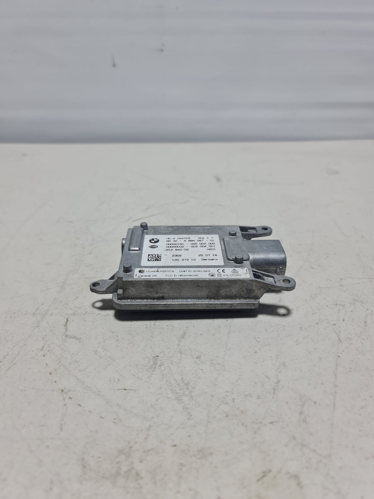 BMW 330i passenger camera and projector radar unit for adaptive cruise control, OEM 2018 model, installed on vehicle side.