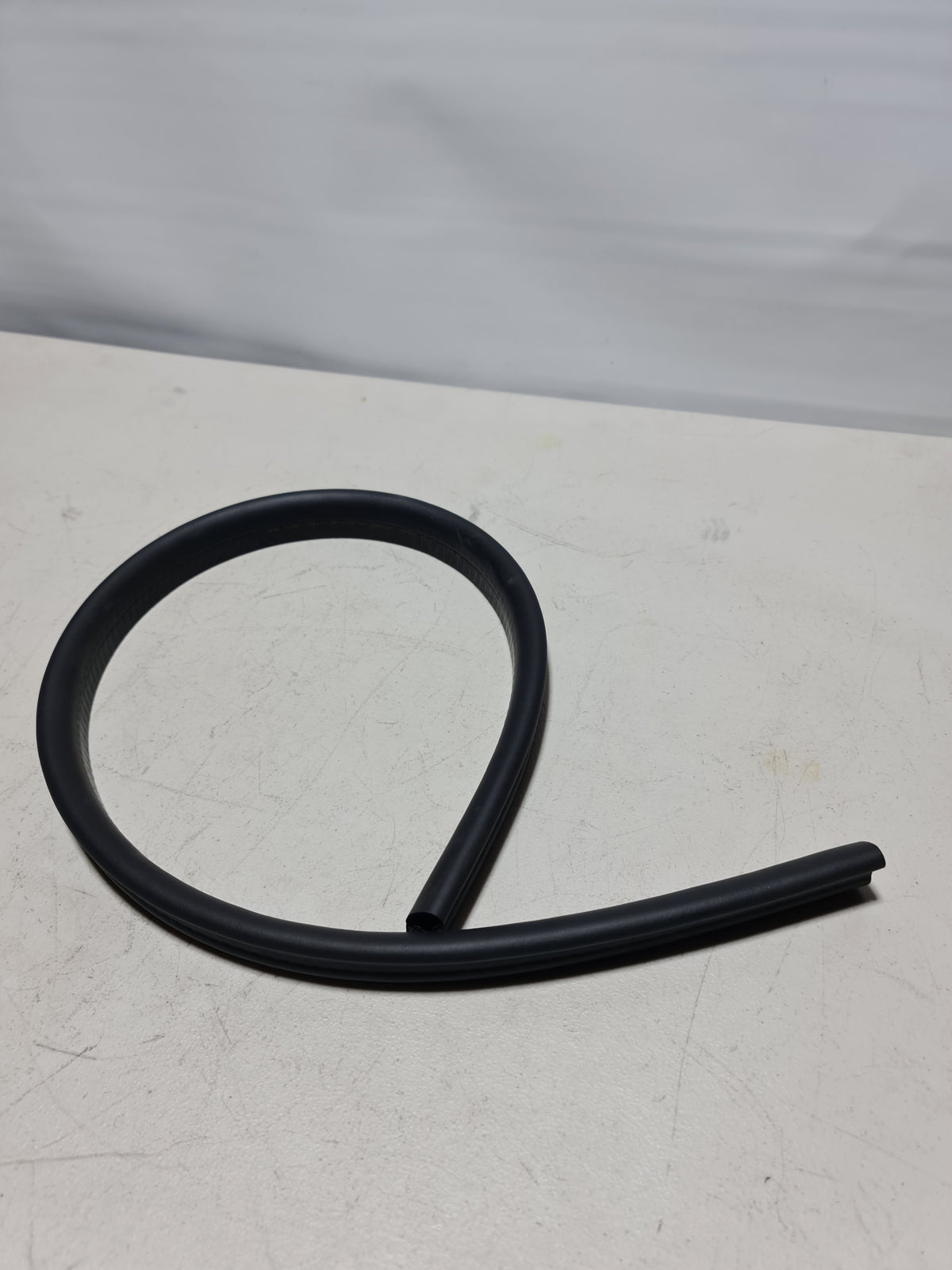 BMW load-through facility trim cover for 2012-2020 models, fits load-through opening, durable black plastic part.