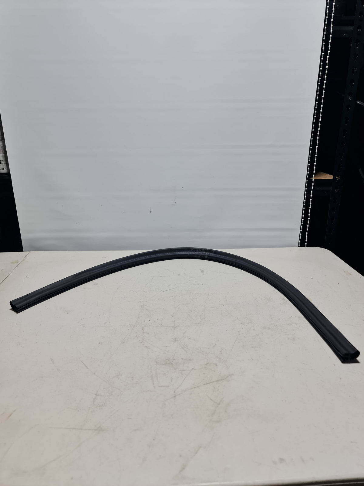 BMW 2012-2020 load-through facility trim cover for BMW 51477240785, black plastic with textured surface and mounting clips.