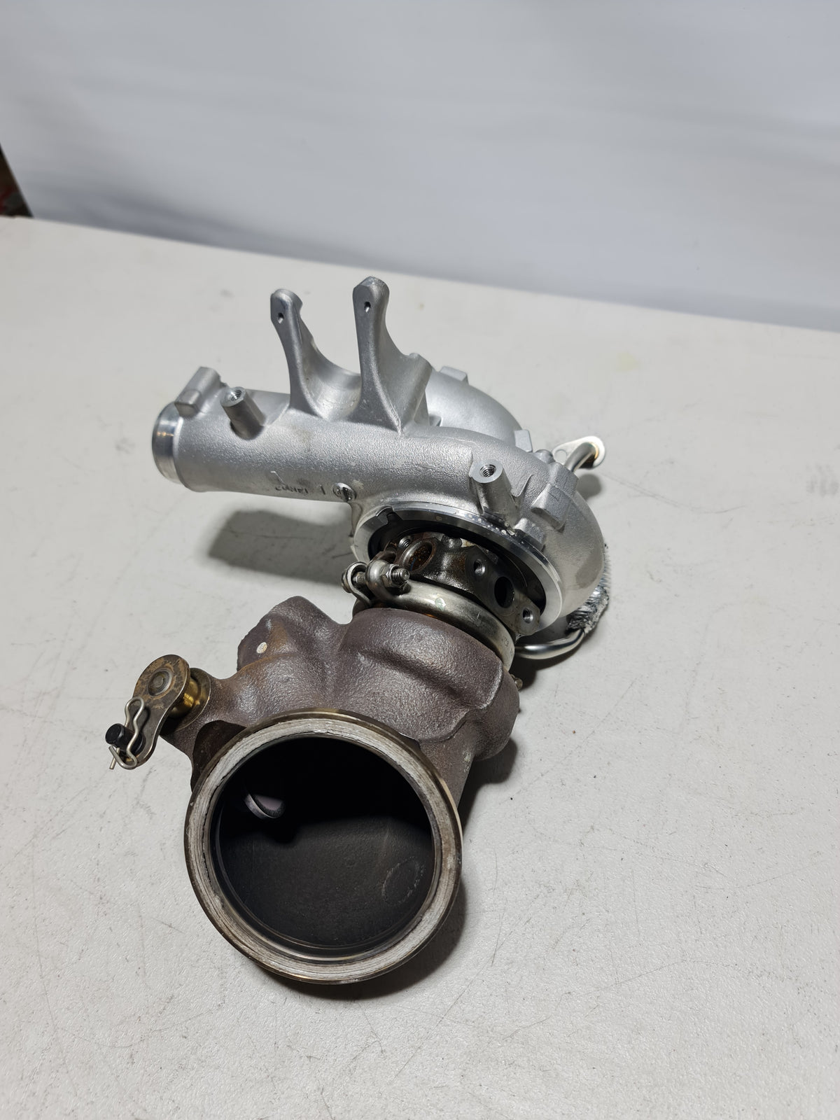 BMW 11657850279 turbocharger for 4-cylinder engines, showing the metallic turbocharger unit with inlet and outlet ports.