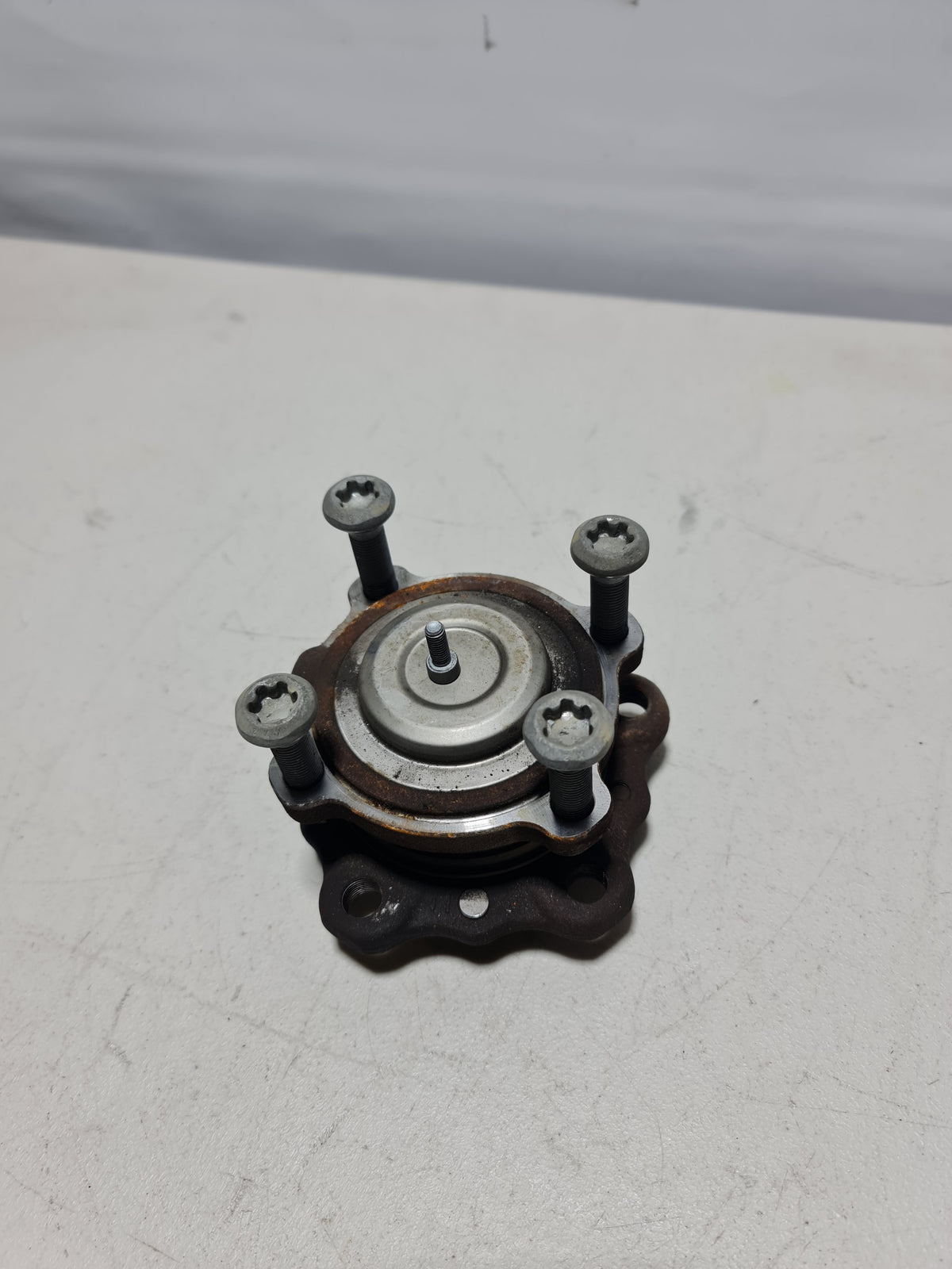 BMW front wheel hub with bearing, model 2015-2020, showing the metallic hub assembly with mounting points and bearing details.