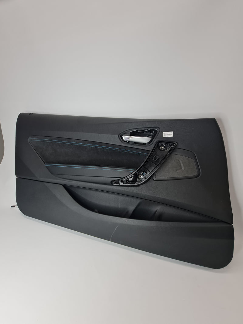 Black leather door card with blue stitching for F87 M2 passenger side by MPerformance.parts, showing detailed stitching and texture.