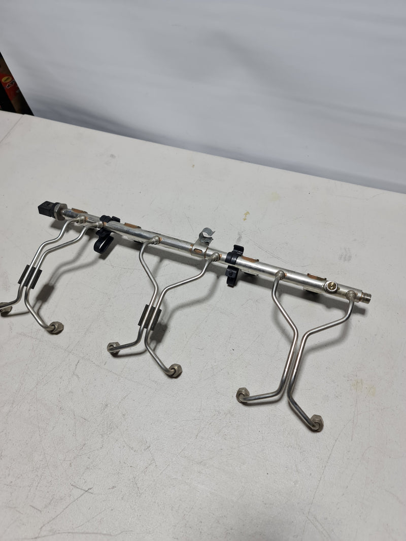 BMW F80 F82 F83 F87 M2 M3 M4 S55 fuel injection rail by MPerformance.parts, showing the metal rail with connectors and fittings.