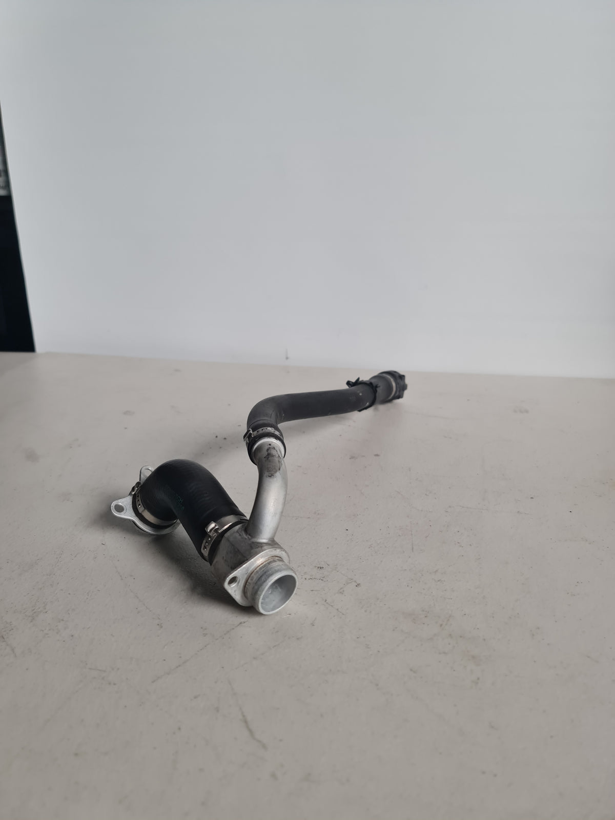 BMW F80 F82 F83 M3 M4 S55 engine coolant hose pipe by MPerformance.parts, OEM part 970354157216, showing the flexible rubber hose.