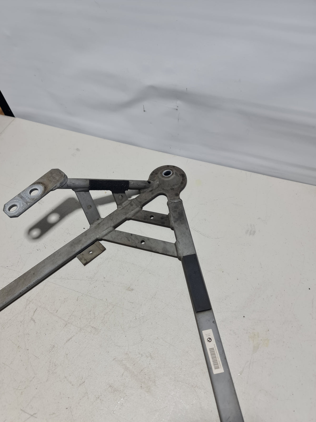 BMW F80 F82 M3 M4 rear right driver subframe brace by MPerformance.parts, showing the sturdy metal component for vehicle stability.