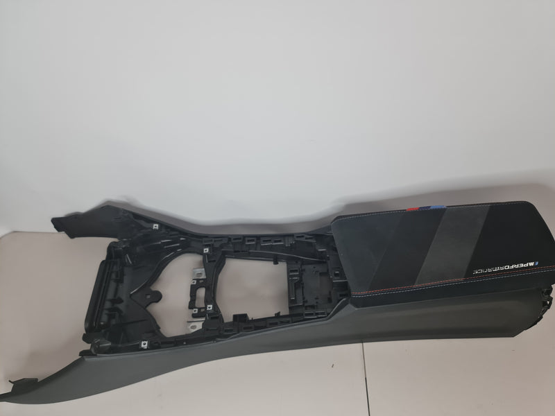 BMW G80 M3 centre console with M Performance arm rest, showing the sleek, black interior component with detailed stitching.