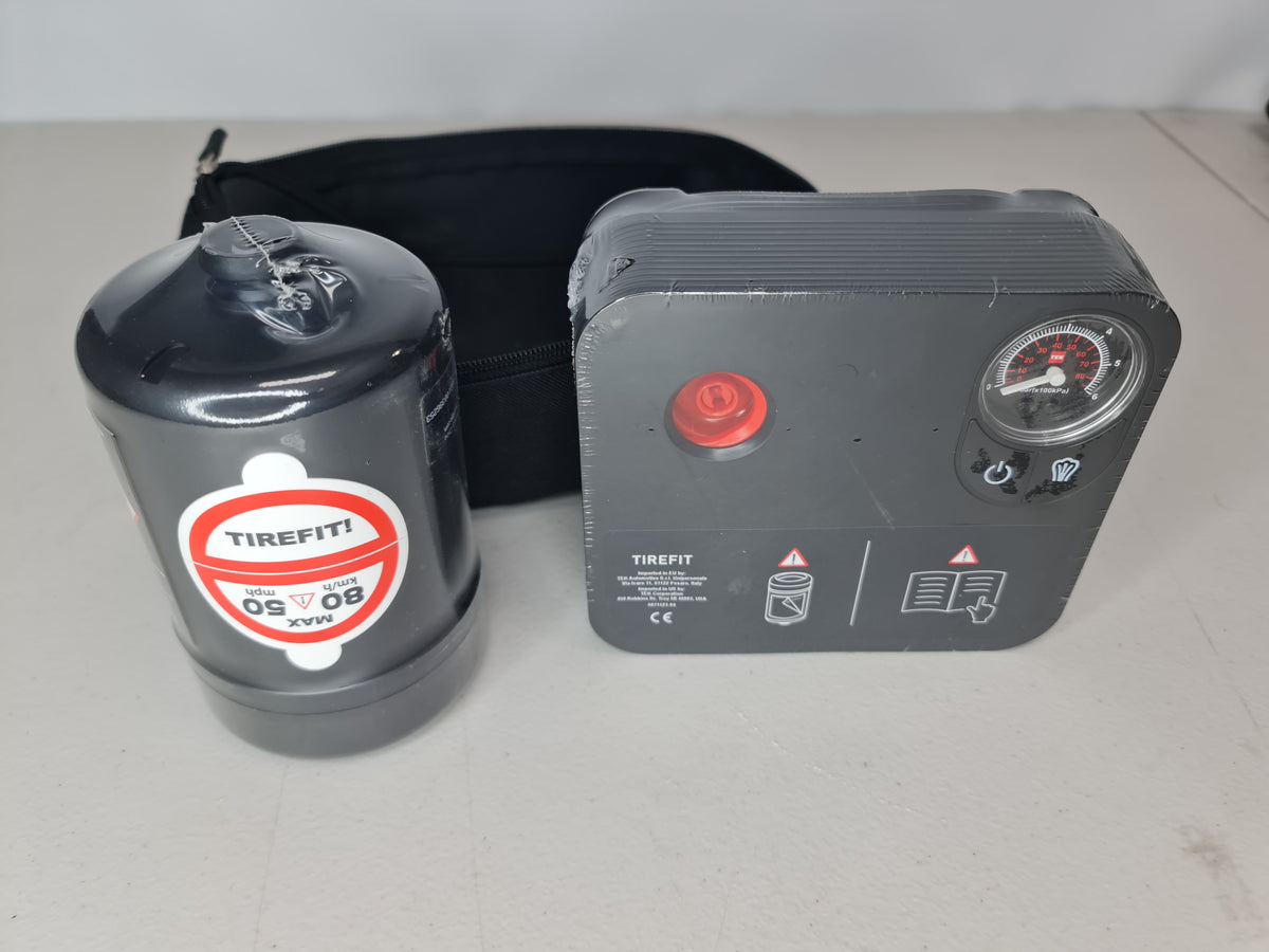 BMW M4 G82 OEM roadside assistance tire inflation kit with slim air pump, compact and portable for emergency tire inflation.
