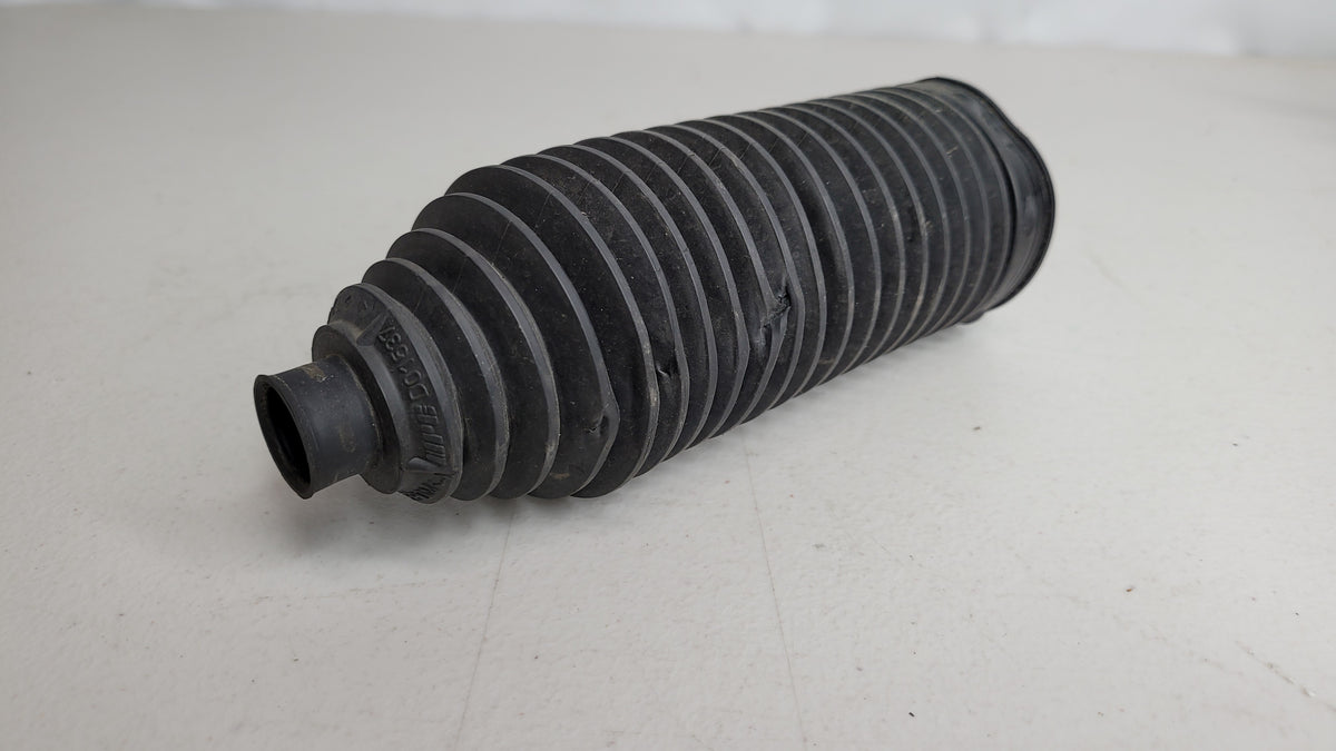 Close-up of MPerformance.parts 04223 automotive part showing detailed metal component with branding etching.