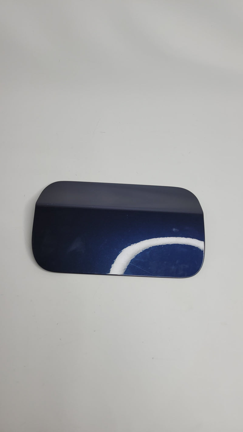 BMW M3 F80 sedan rear fuel tank filler flap cover by MPerformance.parts, showing the sleek metallic exterior and hinge mechanism.