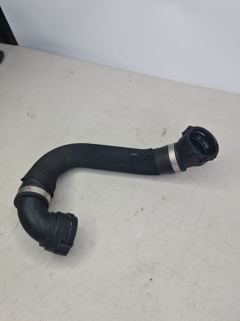 BMW M2 Competition F87 lower radiator hose by MPerformance.parts, showing the black coolant hose with fittings on a white background.