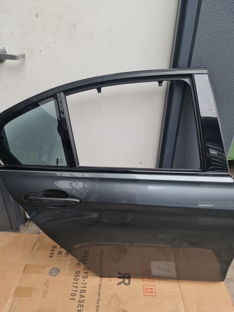 BMW F80 LCI M3 driver door in grey, part of the 3 Series, from MPerformance.parts, showing the door's surface and handle details.