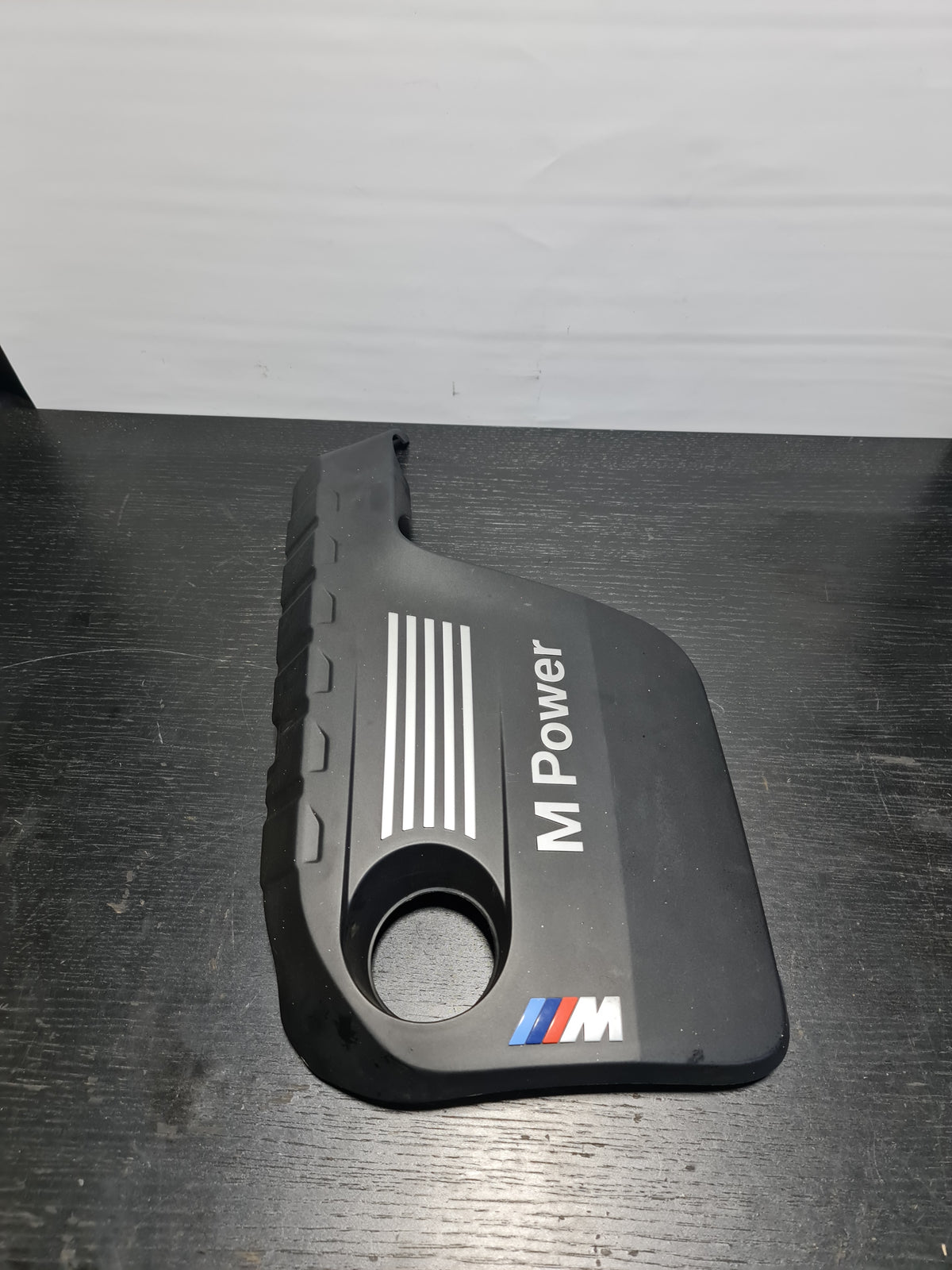 BMW M Power M3 M4 F80 F82 F83 engine cover protection panel by MPerformance.parts, showing the sleek black engine cover with branding.
